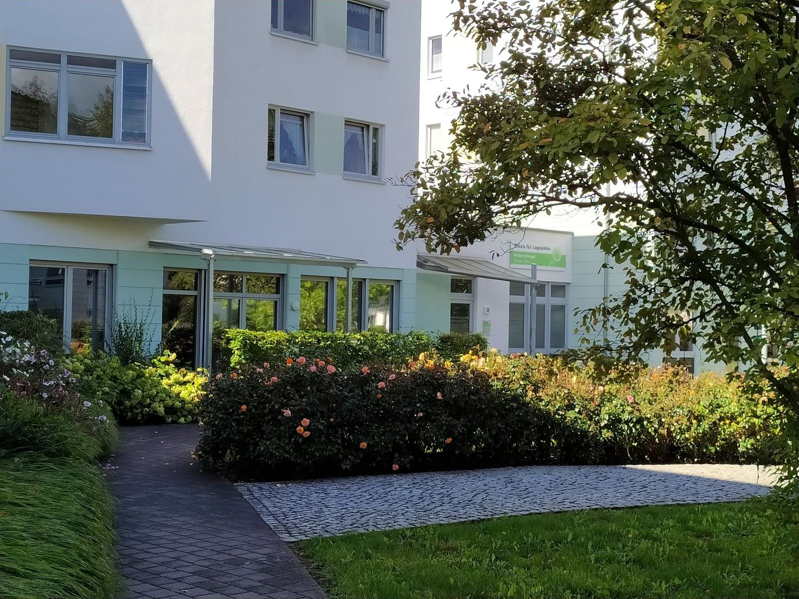 Begrünter Innenhof mit Weg zum Praxiseingang